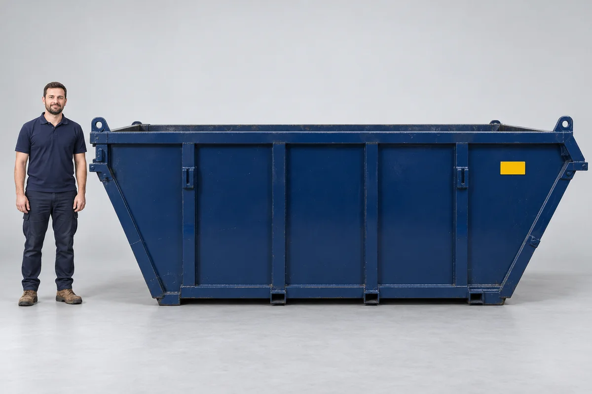 Man standing beside a 12-yard blue skip